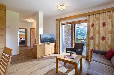 Living room with TV, mountain view, couch in the Alpen Residenz flat